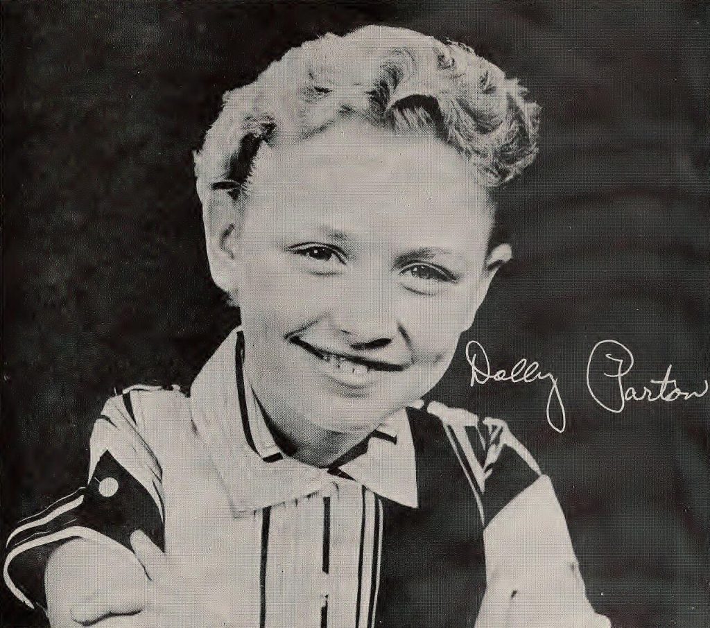 Dolly Parton as a child of about twelve, smiling, in a 1959 photograph.