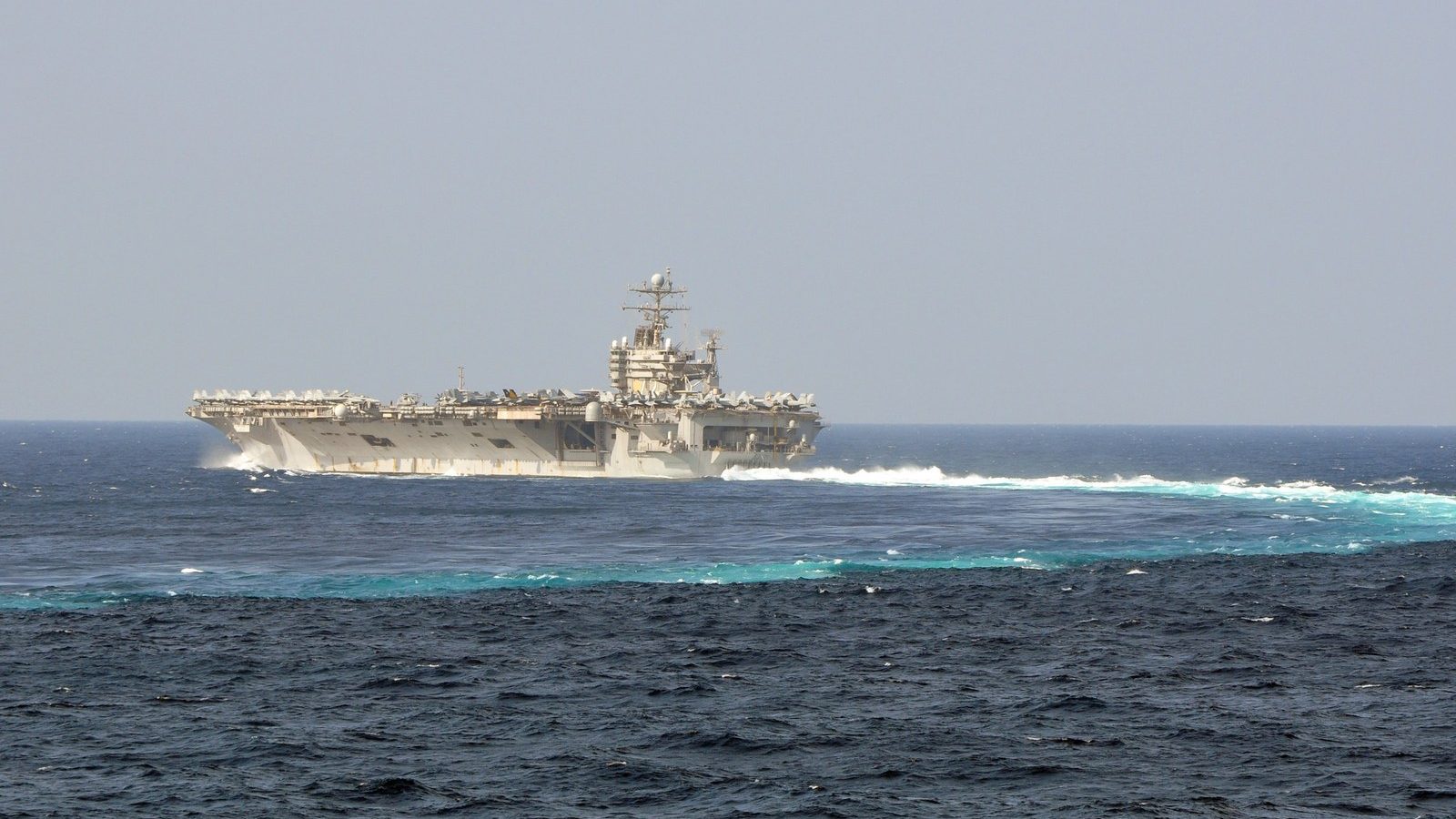 The aircraft carrier USS Abraham Lincoln underway at sea, viewed from off its port side