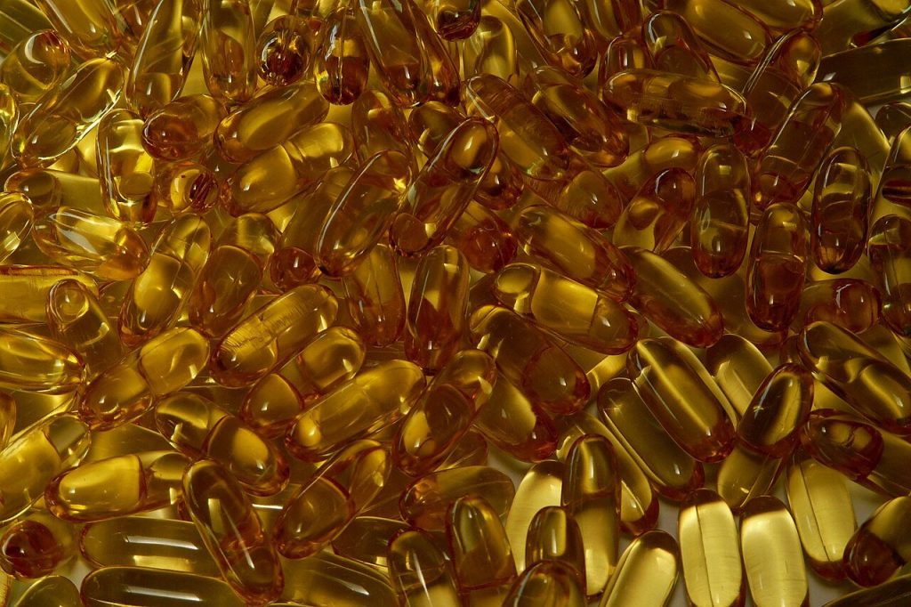 A mass of golden supplement capsules