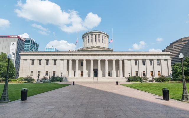 The Ohio Statehouse building in Columbus under a blue sky