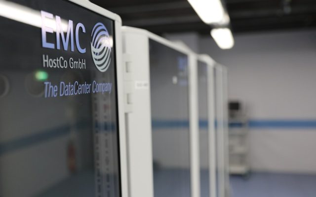 A tall rack of networking and server hardware, densely packed with cabling and status lights.