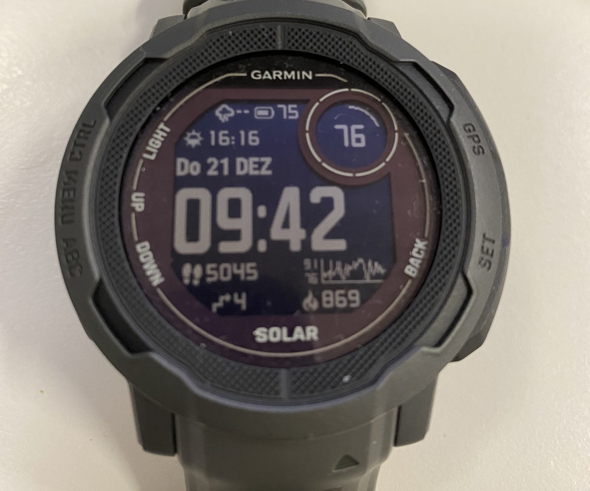 A GPS fitness watch face showing a step count of about 5,000, plus the day's floors and calories.