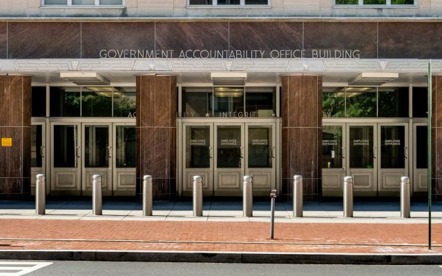 Entrance of the Government Accountability Office Building in Washington, with its name carved above granite columns and security bollards
