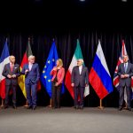 Seven foreign ministers stand in a row in front of national flags in Vienna after announcing the Iran nuclear deal