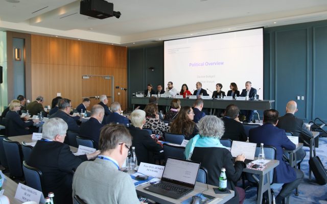 Rows of observers at desks with laptops and country name cards face a panel of eight ODIHR staff under a screen reading Limited Election Observation Mission, General Elections, USA, 5 November 2024
