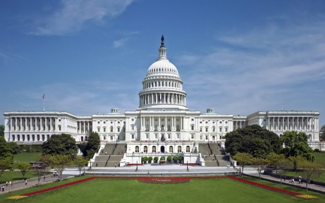 The west front of the United States Capitol under a clear sky.