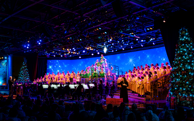 A massed choir and orchestra perform the Candlelight Processional at EPCOT.