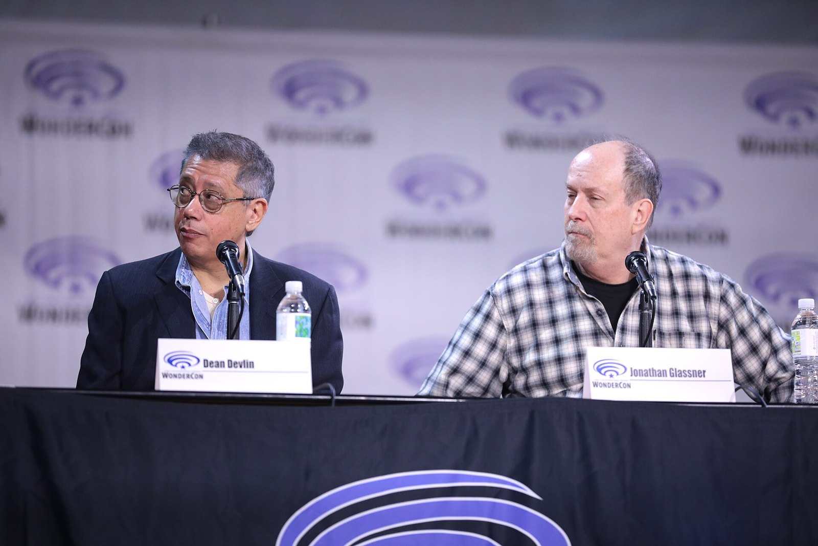 Dean Devlin and Jonathan Glassner seated at a WonderCon panel table