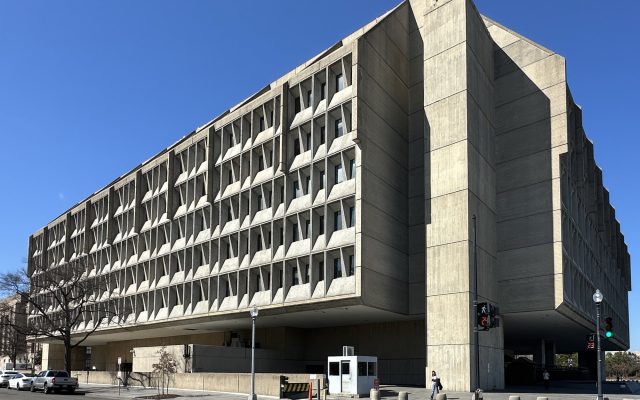 The concrete Hubert H. Humphrey Building, headquarters of the U.S. Department of Health and Human Services, under a clear blue sky