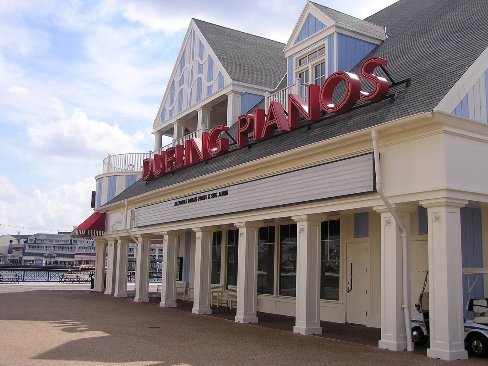 The white BoardWalk building with a red Dueling Pianos sign over the old Jellyrolls entrance