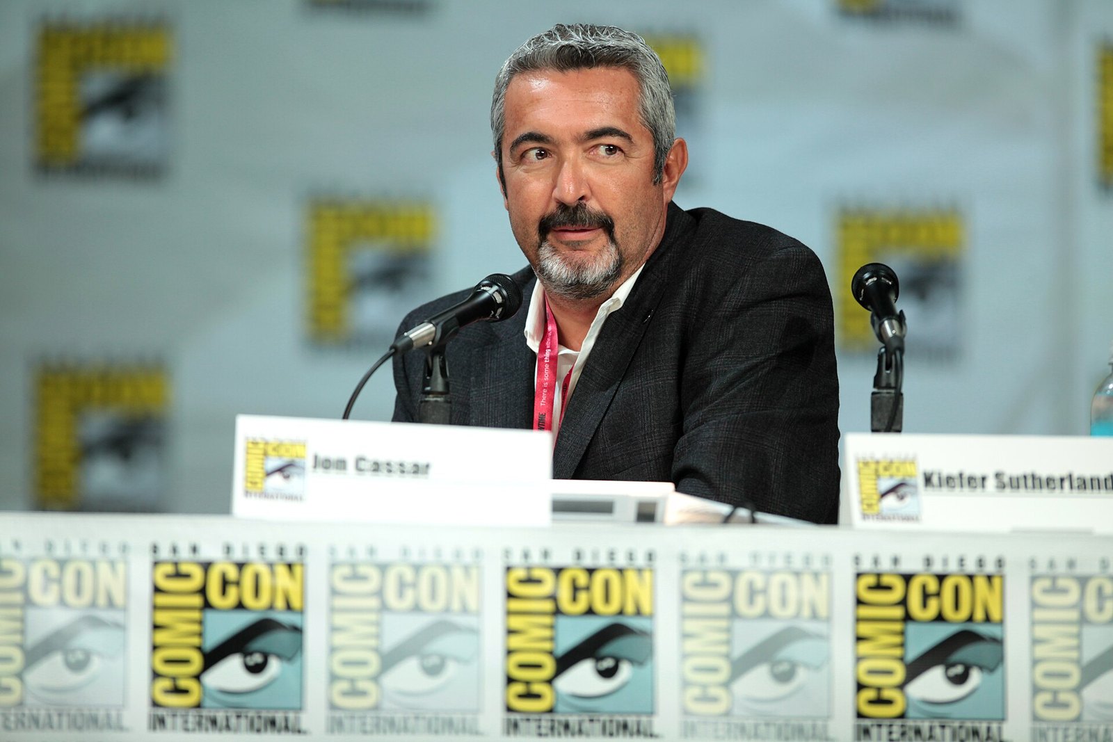 Director Jon Cassar speaking at a San Diego Comic-Con panel table