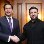 Secretary of State Marco Rubio shakes hands with Ukrainian President Volodymyr Zelenskyy in a wood-paneled room