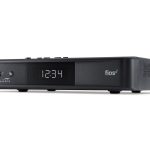 A black Verizon Fios set-top box with a digital clock display on a white background