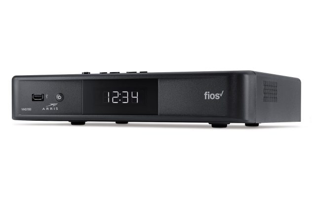 A black Verizon Fios set-top box with a digital clock display on a white background